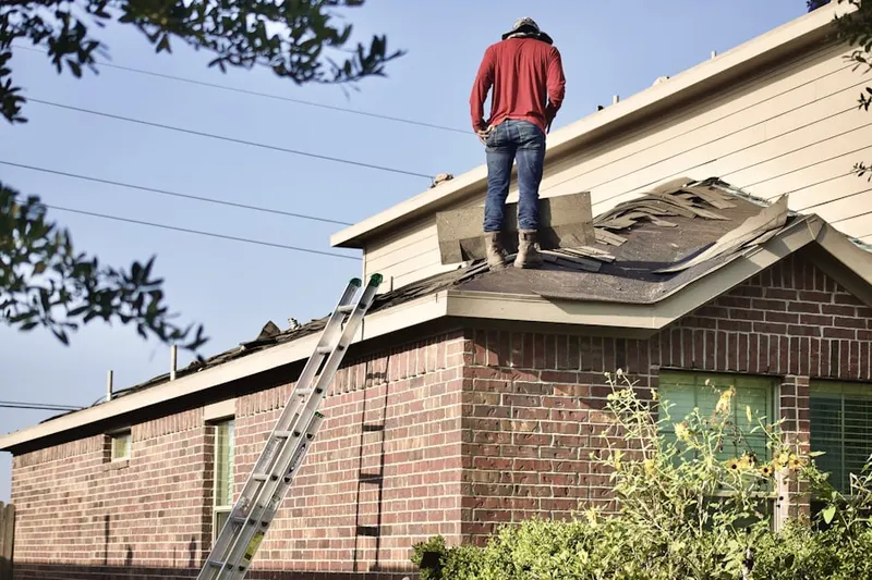 Professional roofer working on a residential roof in Island Creek